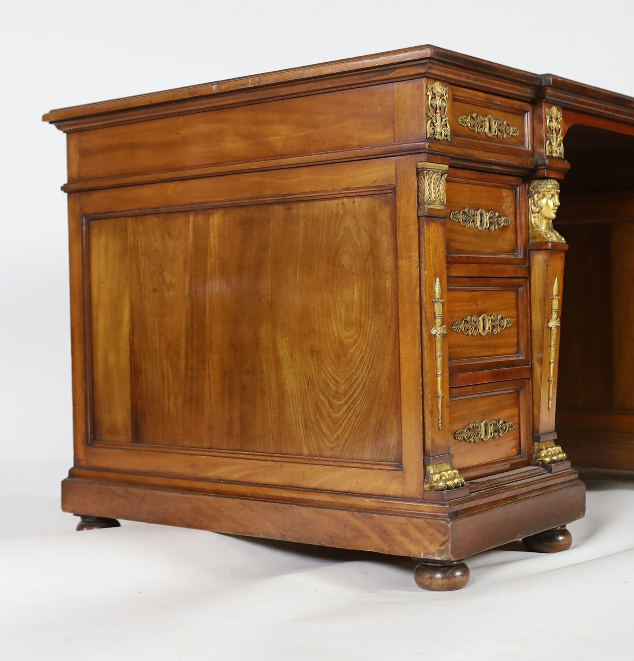 An early 20th century French classical revival mahogany breakfront pedestal desk, W.135cm D.82cm H.75cm